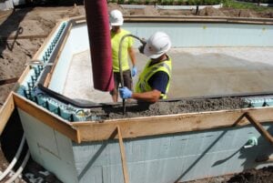 Construction workers using concrete forms